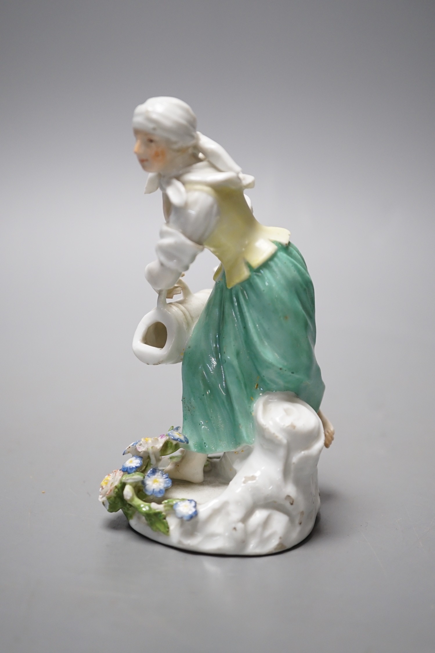 An 18th century Meissen figure of a girl pouring water from a jug on flowers at her feet, c.1755, 12cm tall